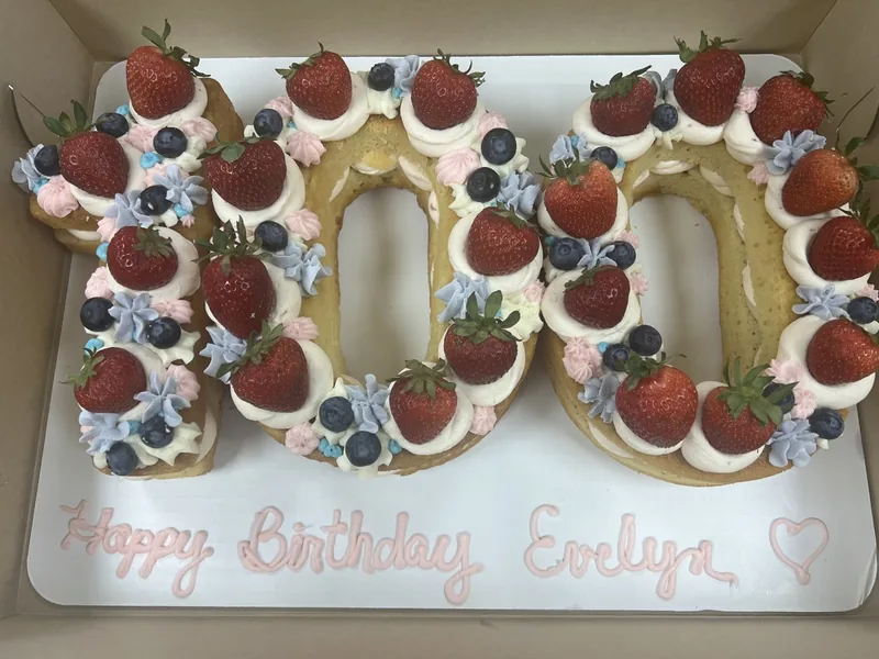 Number cake decorated with berries and flowers